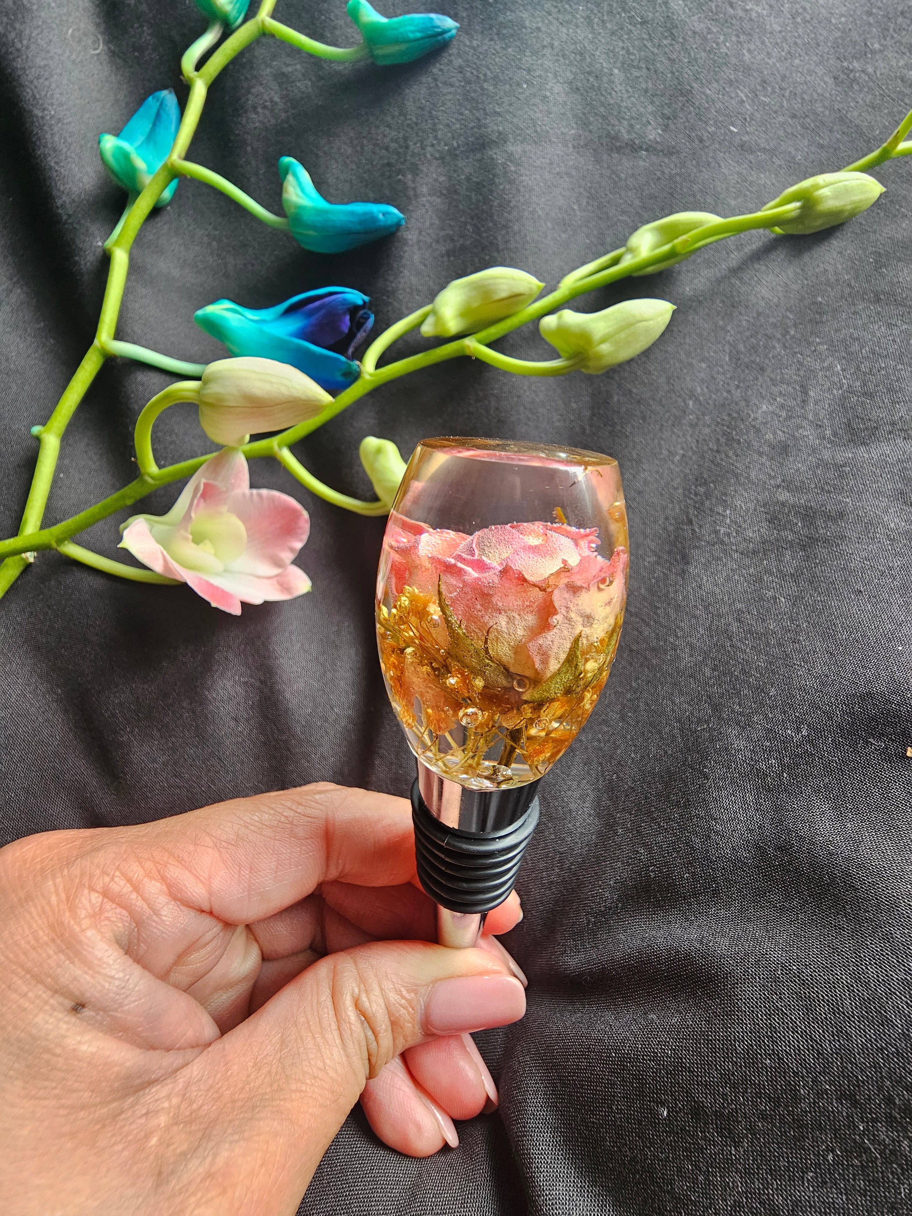 Pair of wine bottle stoppers made with preserved wedding bouquet flowers – handmade by Alma Makes