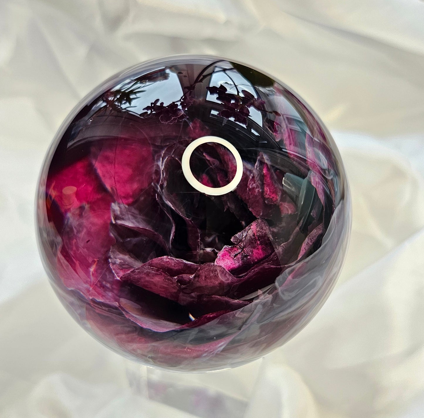 Memorial flowers preserved in a clear resin sphere keepsake