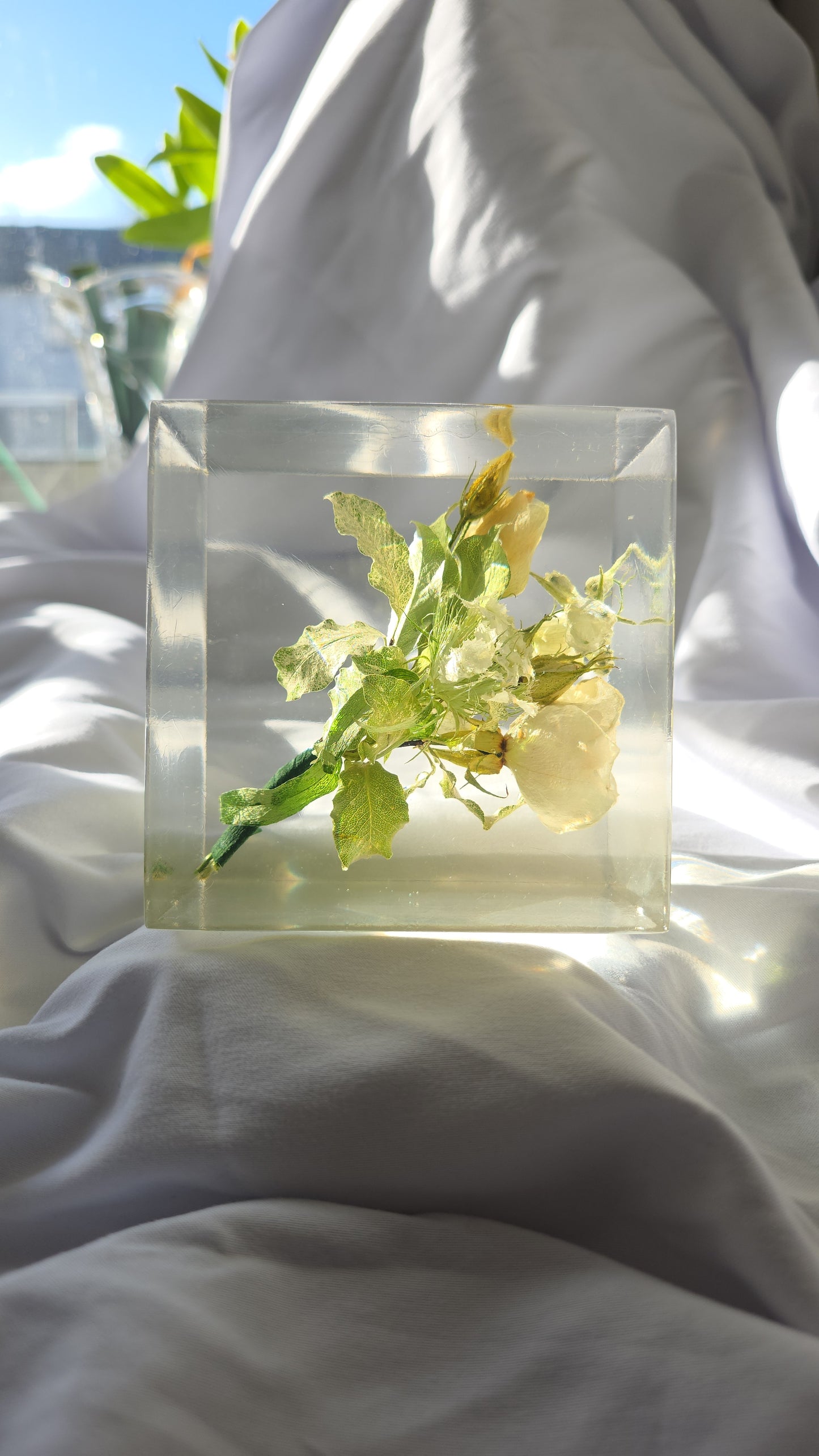 Wedding boutonnière preserved in a clear resin block with PRESERVED FLOWERS